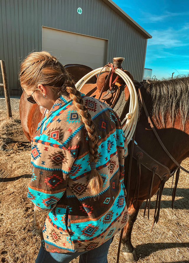 Back view of women in a blue brown winter sherpa-lined shirt jacket