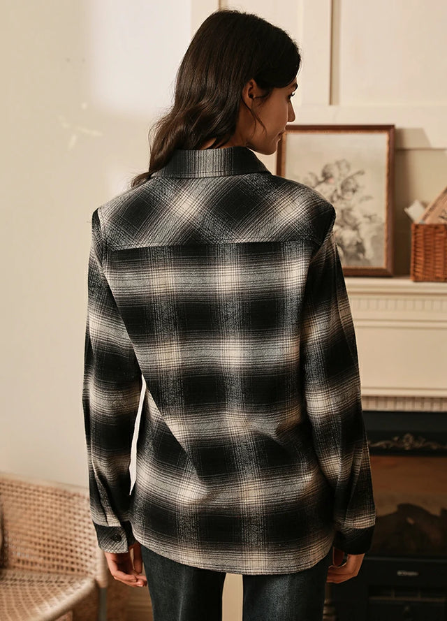 Back view of women in a gray white button up flannel plaid shirt