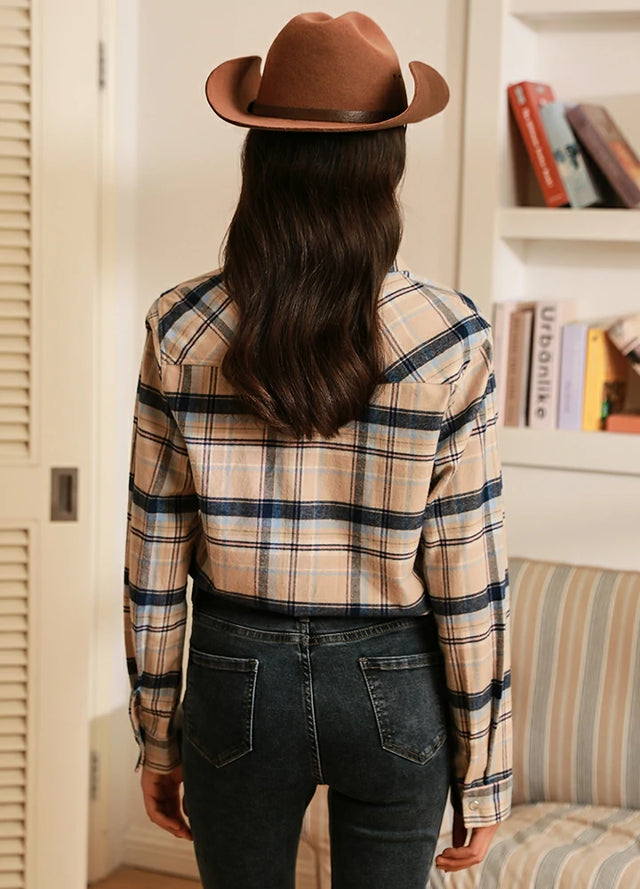 Back view of women in a khaki navy plaid soft flannel shirt