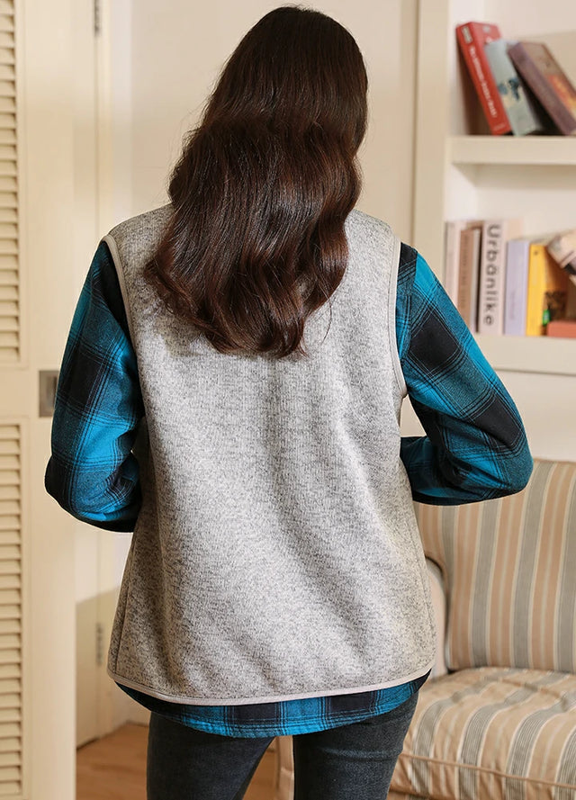 Back view of women in a light gray full zip fleece vest