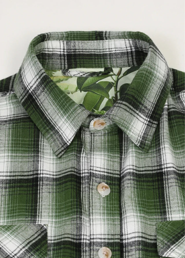 Close-up of men's forest green printed flannel shirt collar
