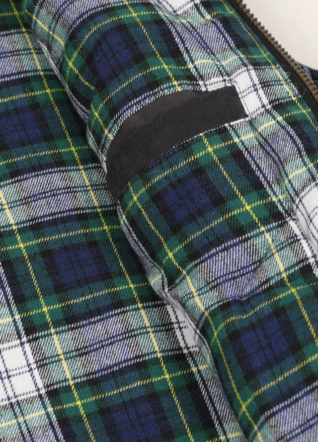 Close-up of the womens inner pocket of a black puffer vest with flannel lining