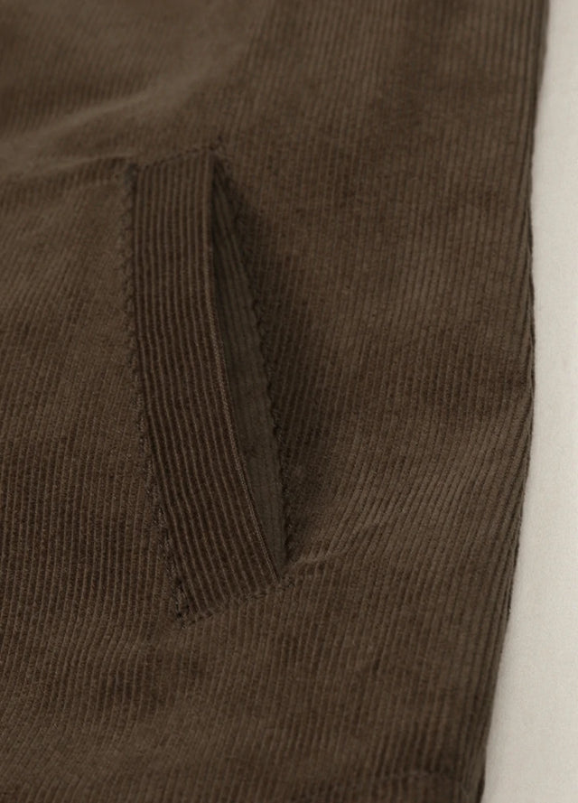 Close-up of women's dark brown corduroy shacket side pocket