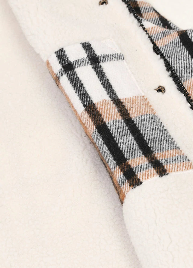 Close-up of women's black white full zip sherpa lined plaid vest inner pocket