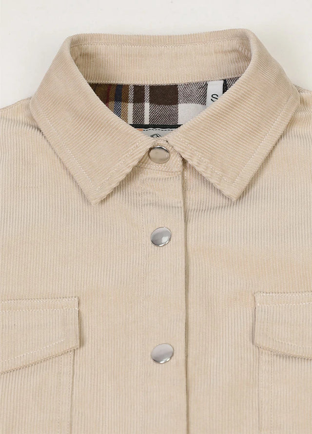 Close-up of women's light khaki flannel-lined corduroy shacket collar