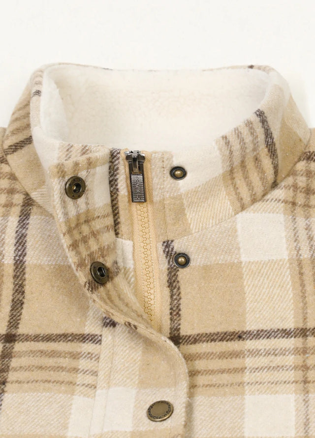 Close-up of women's light khaki sherpa lined zip up plaid vest collar