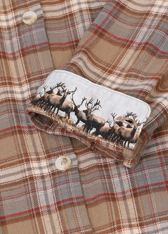 Close-up of women's lightweight brown plaid flannel shirt cuffs