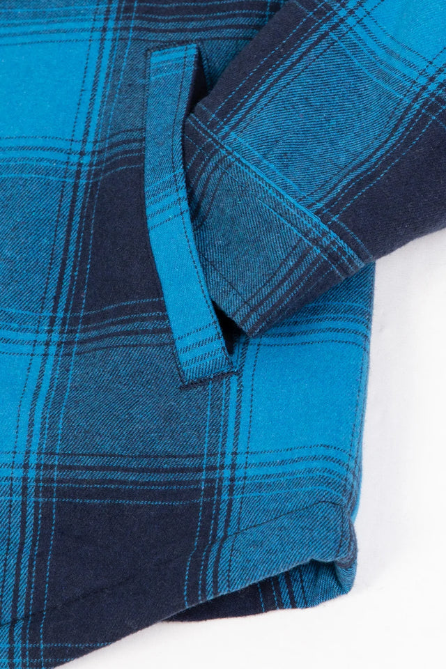 Close-up of women's long sleeves blue black flannel shacket hand pocket