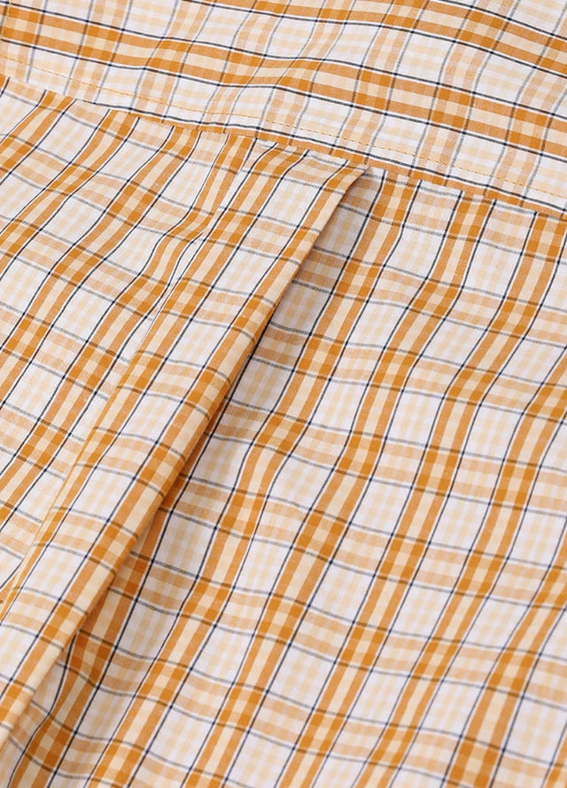 Close-up of women's pearl snap western orange white plaid vest back design