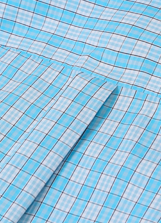 Close-up of women's pearl snap western baby blue plaid vest back design
