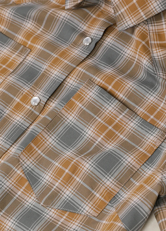 Close-up of women's summer brown gray snap button shirt chest pocket