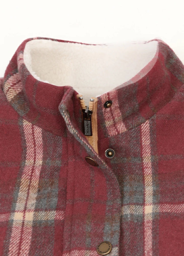 Close-up of women's purple sherpa lined zip up plaid vest collar