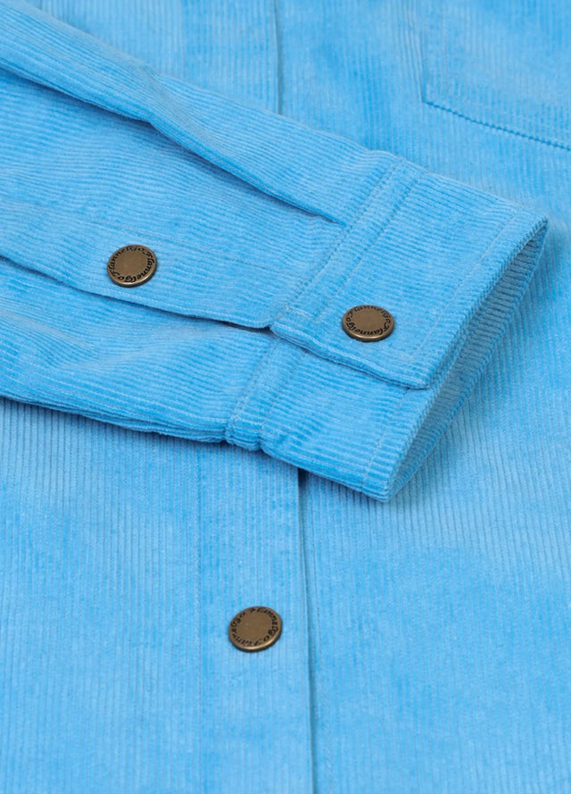 Close-up of womens blue corduroy shirt jacket cuffs