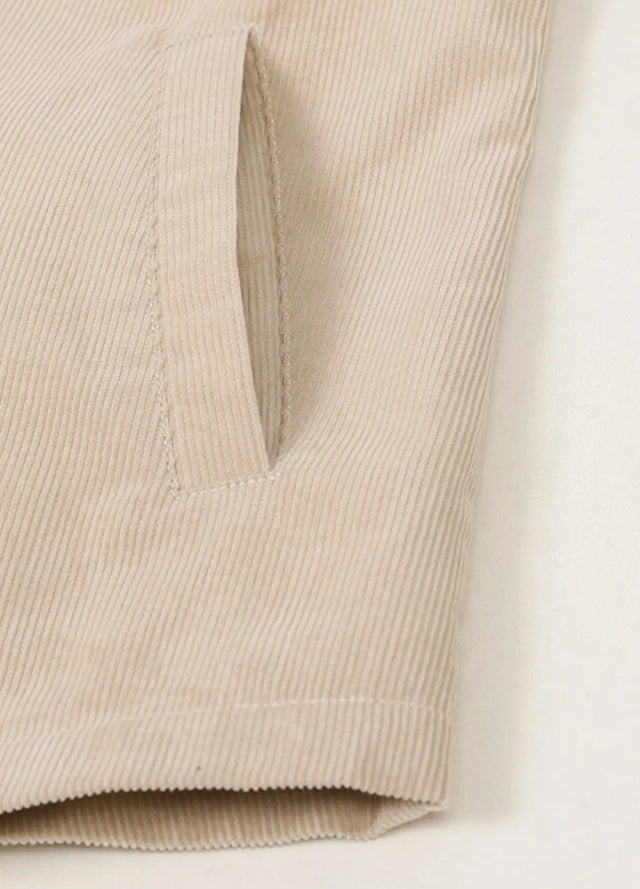 Close-up of womens light khaki corduroy shirt jacket side pocket