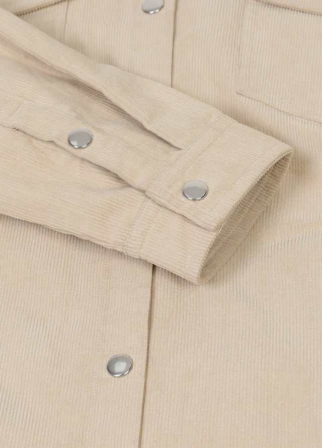 Close-up of womens light khaki flannel-lined corduroy shacket cuffs