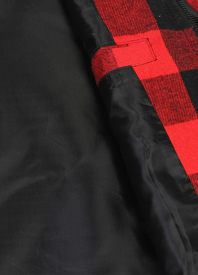Close-up of women's black and red sleevesless quilted flannel plaid vest collar