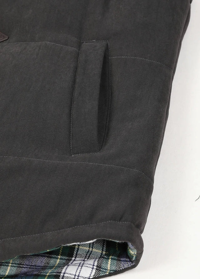 Close-up view of the womens side pocket on a black puffer vest