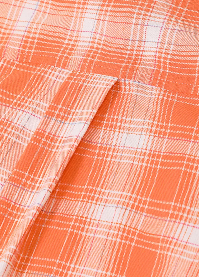 Detailed close-up of the womens orange flannel shirt fabric