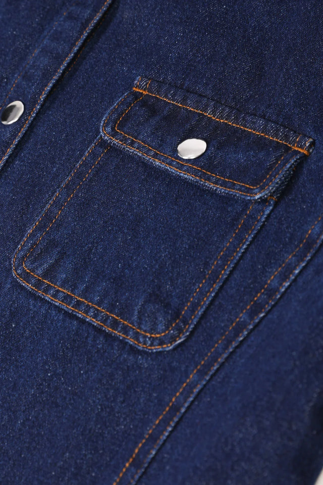 Detailed view of women's dark blue flannel lined denim shacket front pocket