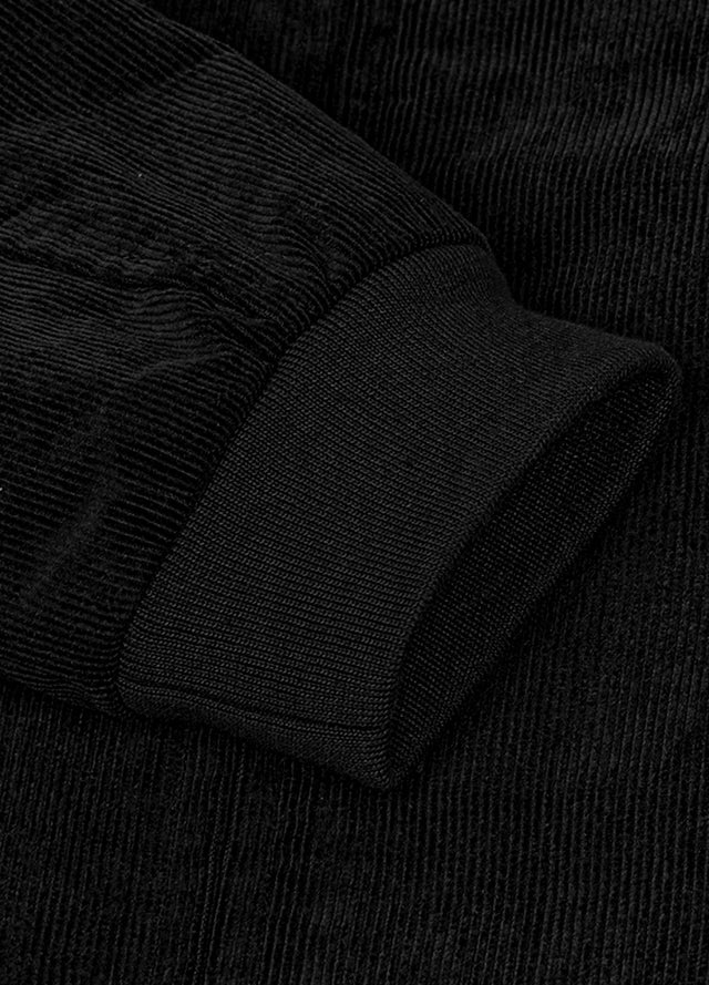 Detailed view of women's full zip up cozy black corduroy jacket cuffs