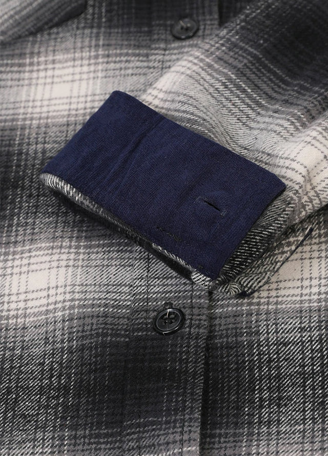 Detailed view of women's gray white cotton plaid flannel shirt cuffs