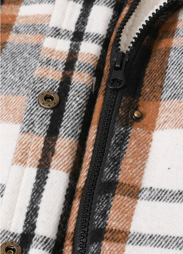 Detailed view of women's black white winter warm sherpa lined plaid vest zipper