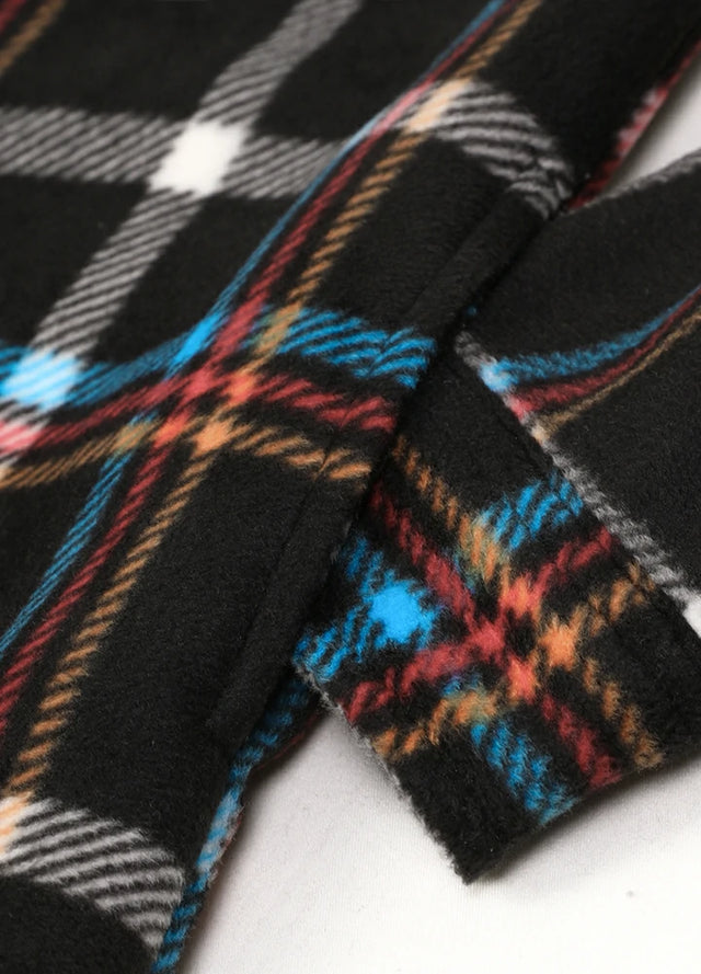 Detailed view of women's black button down plaid shacket hand pocket