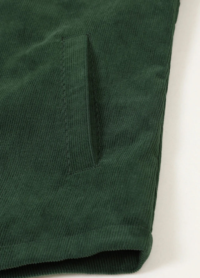 Detailed view of womens dark green corduroy shirt jacket side pocket