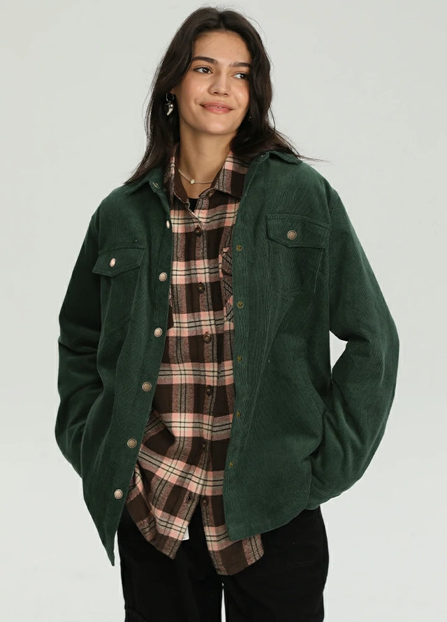 Women wearing a dark green corduroy shirt jacket