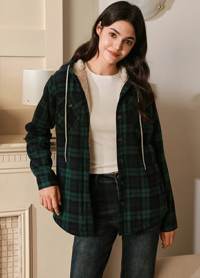 Women in a green and black sherpa lined flannel plaid jacket with hood