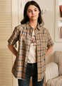 Women in a brown gray short-sleeve summer shirt with snap button
