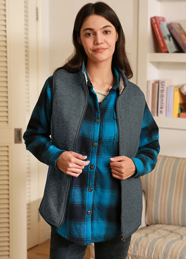 Women in a dark gray warm sherpa lined sweater fleece vest