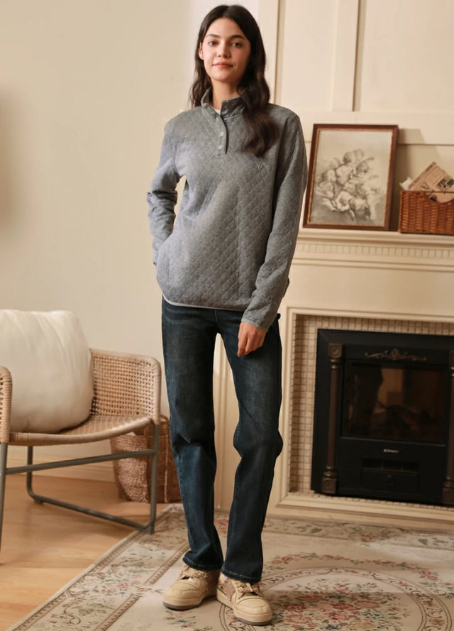 Women in a light gray heather long sleeve quilted fleece pullover