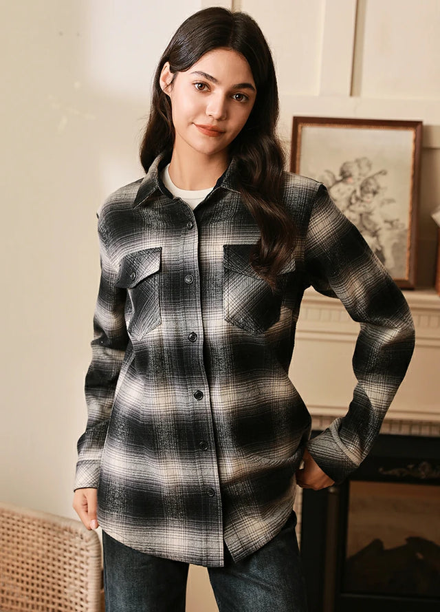 Women in a long sleeve gray white plaid outdoor flannel shir