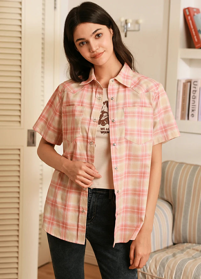 Women in a pink short-sleeve summer shirt with snap button