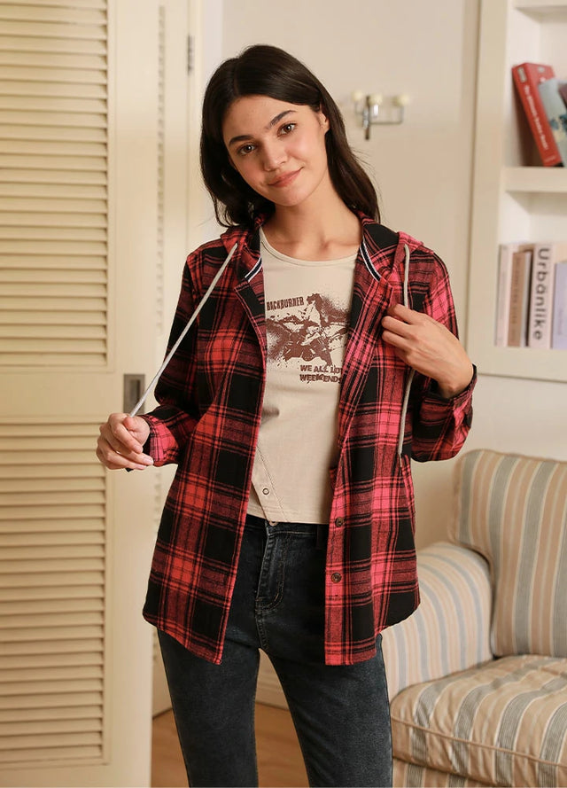 Women in a pink button-up soft flannel shirt with a hoodie