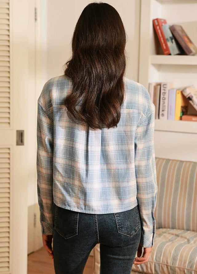 Women in a blue sunmmer flannel shirt back view
