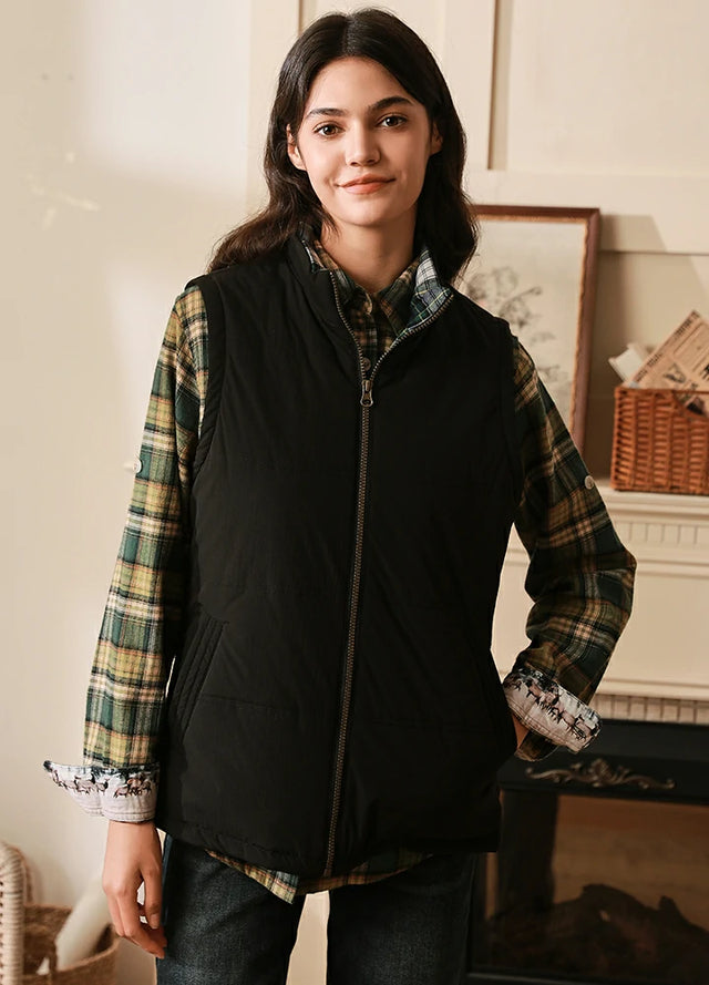 Women wearing a black flannel lined puffer vest with zip up