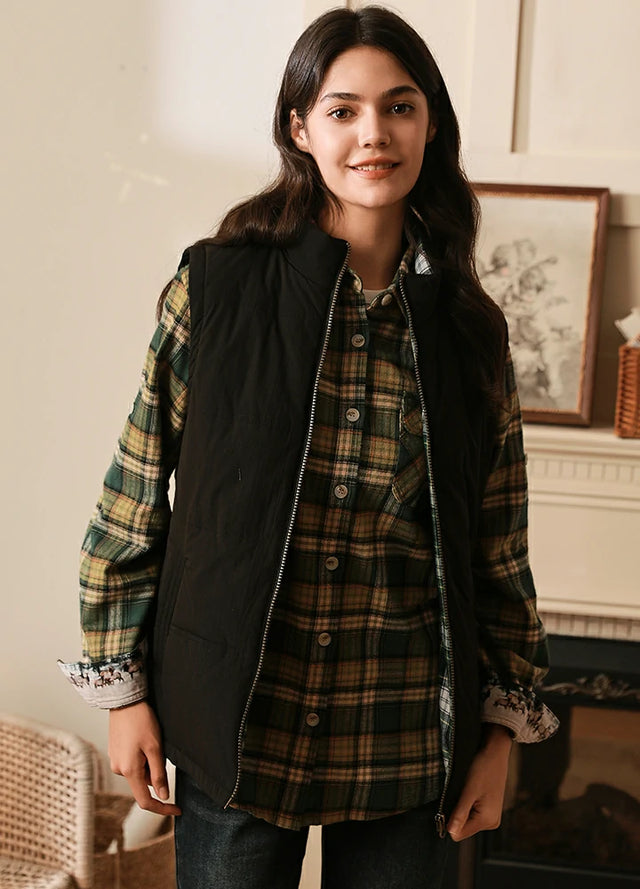 Women wearing a black full-zip puffer vest with flannel lined