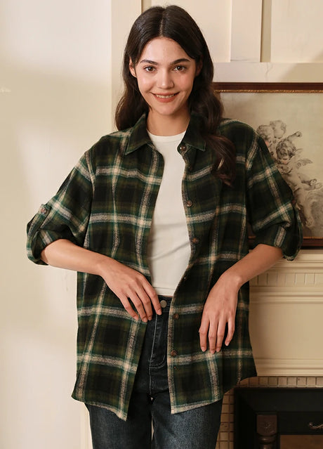 Women wearing a dark green button-up flannel shirt with rolled-up sleeves