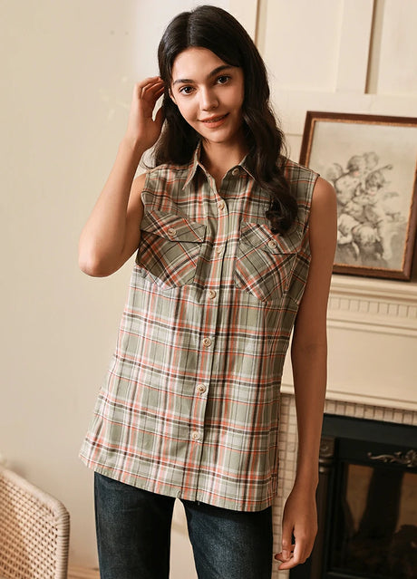 Women wearing a teal green plaid flannel vest