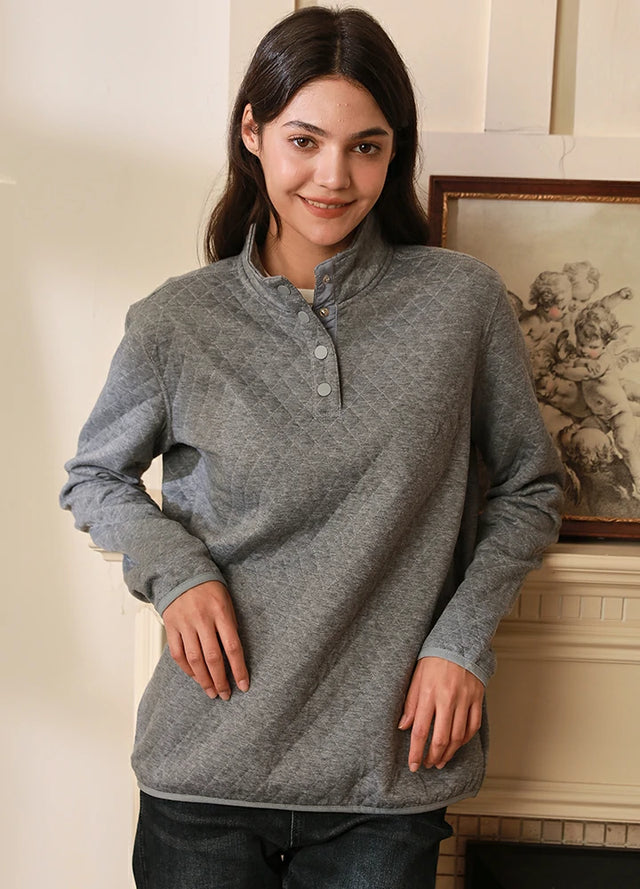 Women wearing a light gray heather quilted fleece pullover shirt