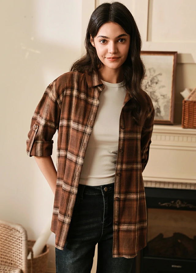 Women wearing a brown button-up flannel shirt with rolled-up sleeves