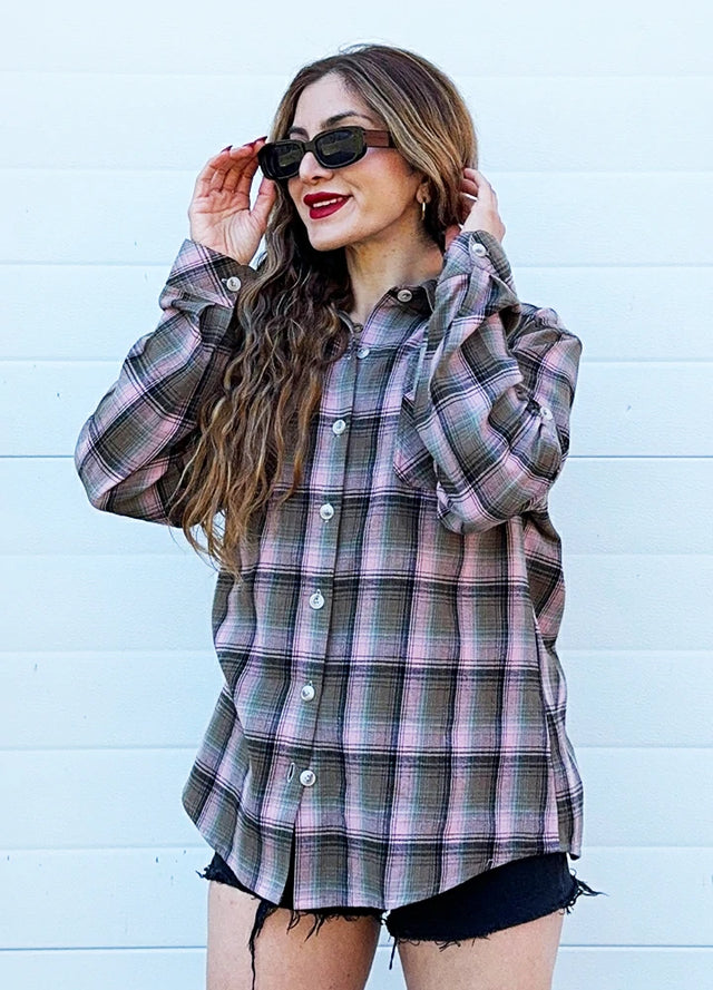 Women wearing a soft pink plaid flannel shirt with printed