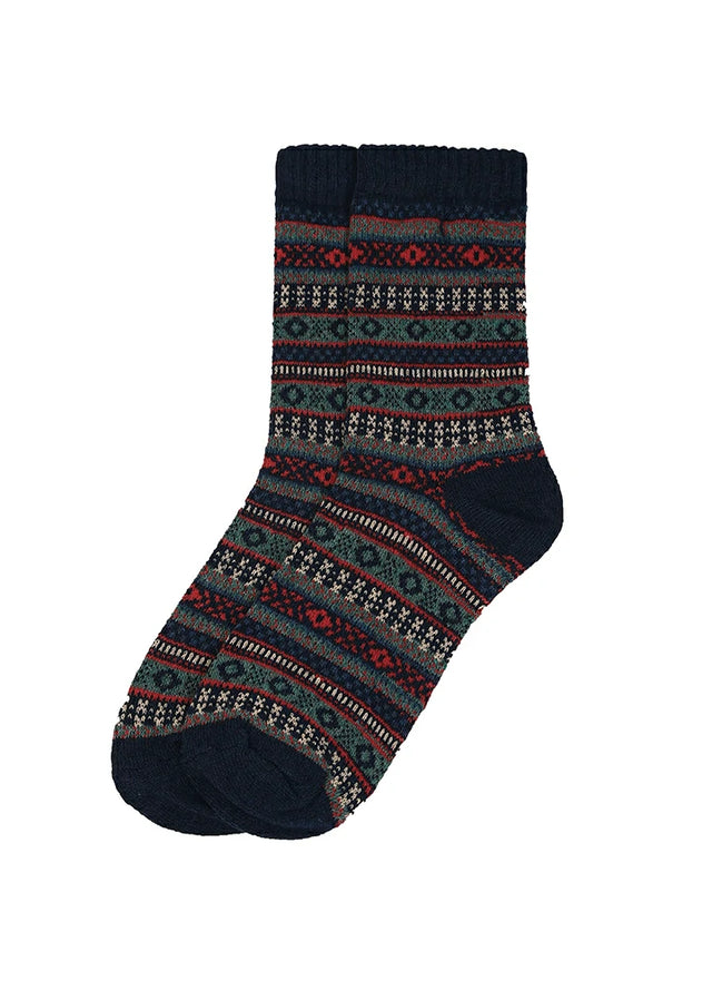 A pair of crew socks with a dark navy blue base and horizontal bands of red, green, and white geometric and floral patterns, shown against a plain white background.