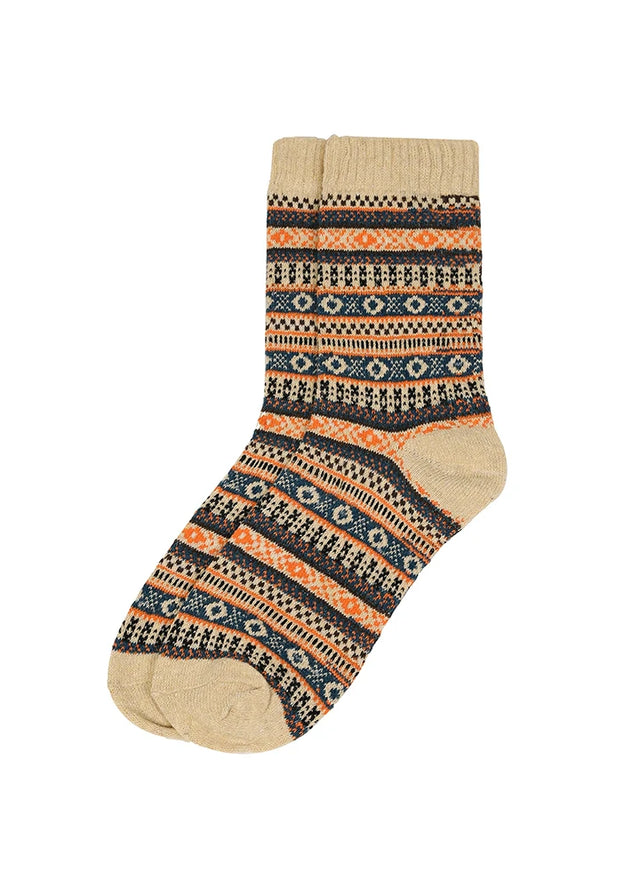 A single crew sock with a multicolor Fair Isle pattern on a solid white background.