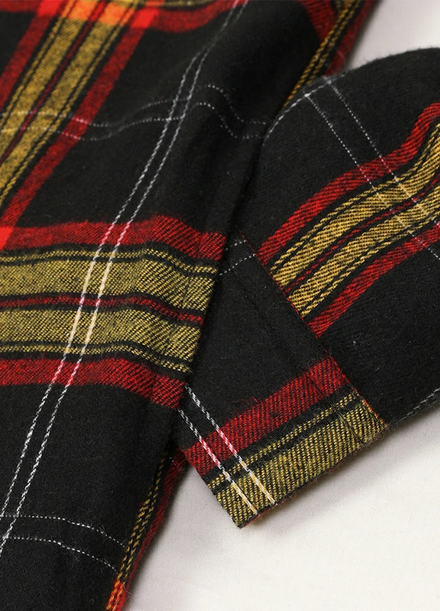 Close-up of the seam pocket of red and black men's workwear flannel shacket with hood