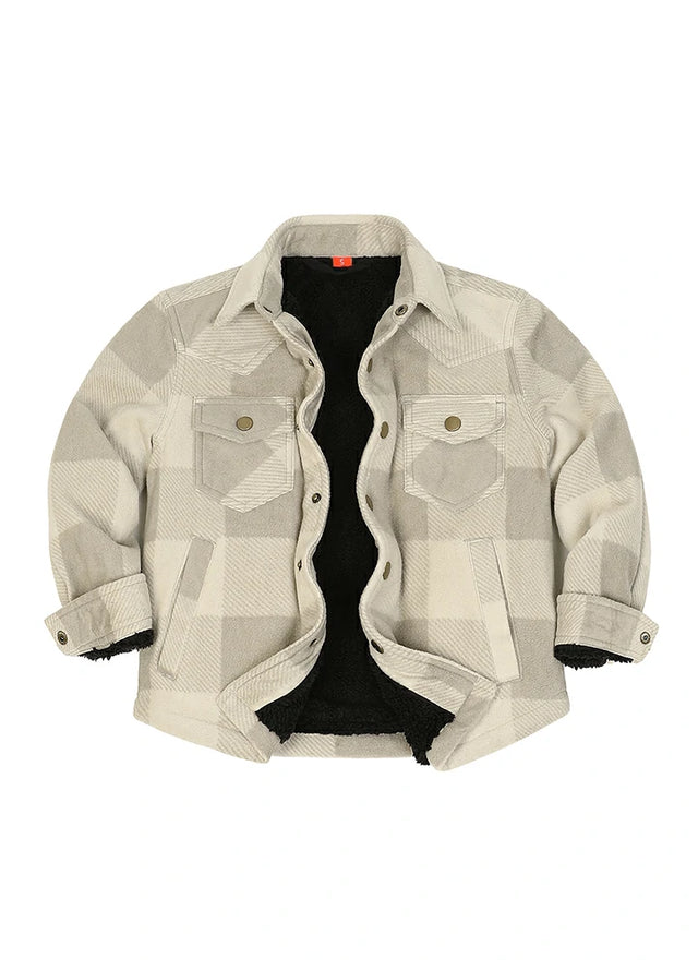 A cropped button-up shirt jacket featuring a beige and gray geometric plaid pattern, a black sherpa lining, and buttoned chest pockets, displayed flat against a white background.