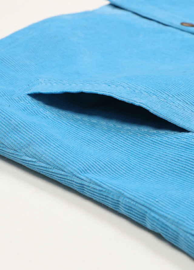 Zoomed-in of women's blue corduroy shirt jacket side pocket