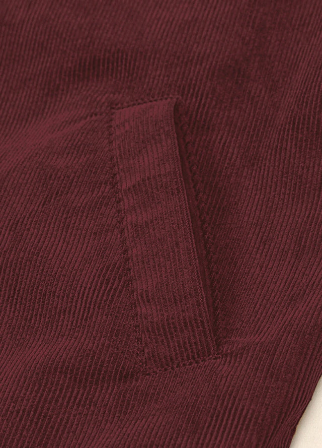Zoomed-in view of the hand pocket on a women's burgundy corduroy jacket